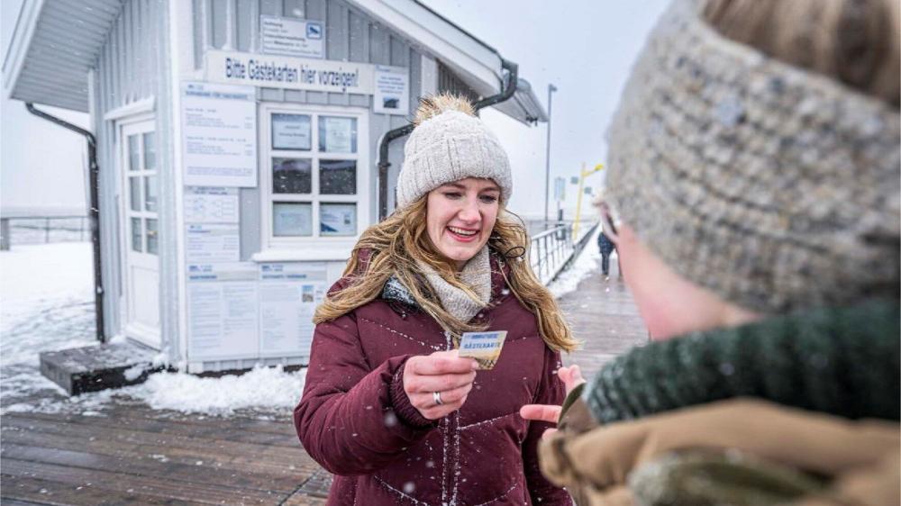Frau mit Gästekarte in St Peter Ording